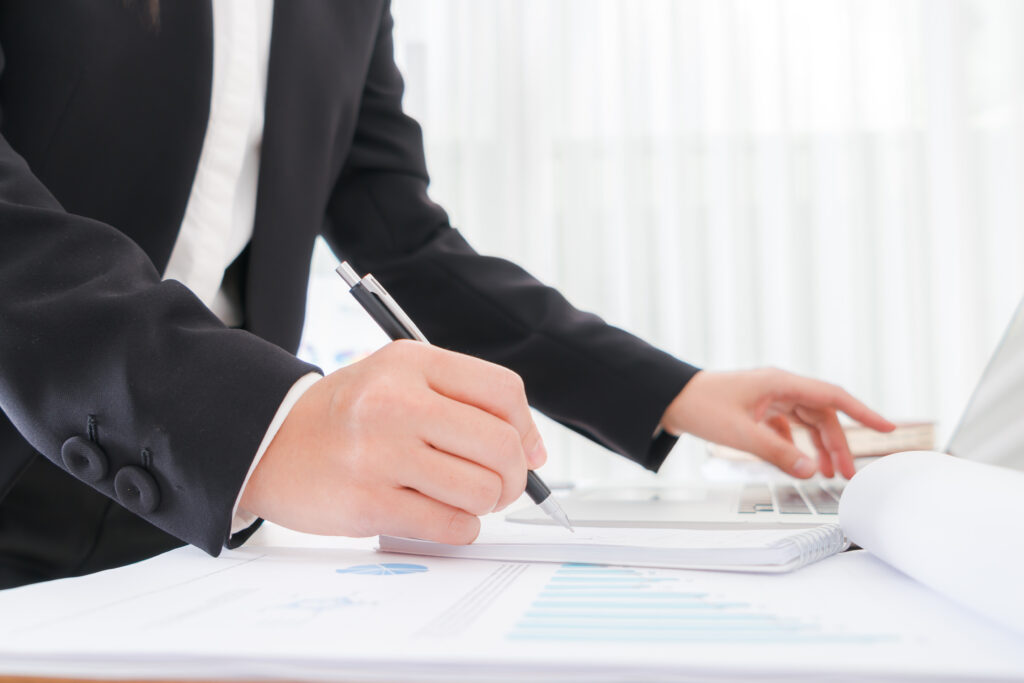 business people using a pencil noting over laptop