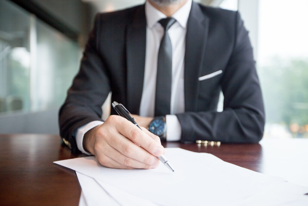 cropped view of business leader making notes
